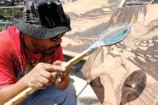 Illustration for article titled This Artist Uses His Magnifying Glass To Burn Pictures, Not Ants